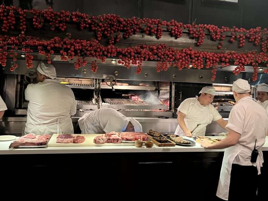 Chefs cooking behind a counter of a restaurant - Argentina food and drinks