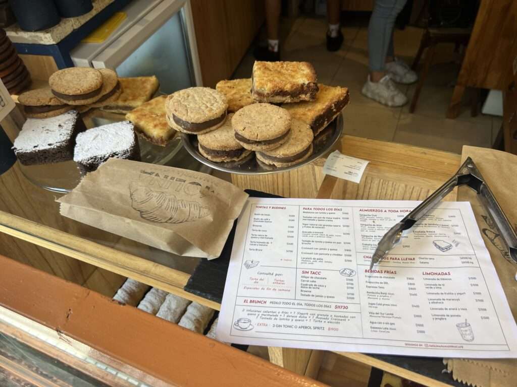 A counter covered in pastries and cookies at a cafe - Argentina food and drinks