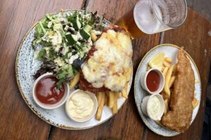 Two plates of food and a glass of beer - australia food and drinks