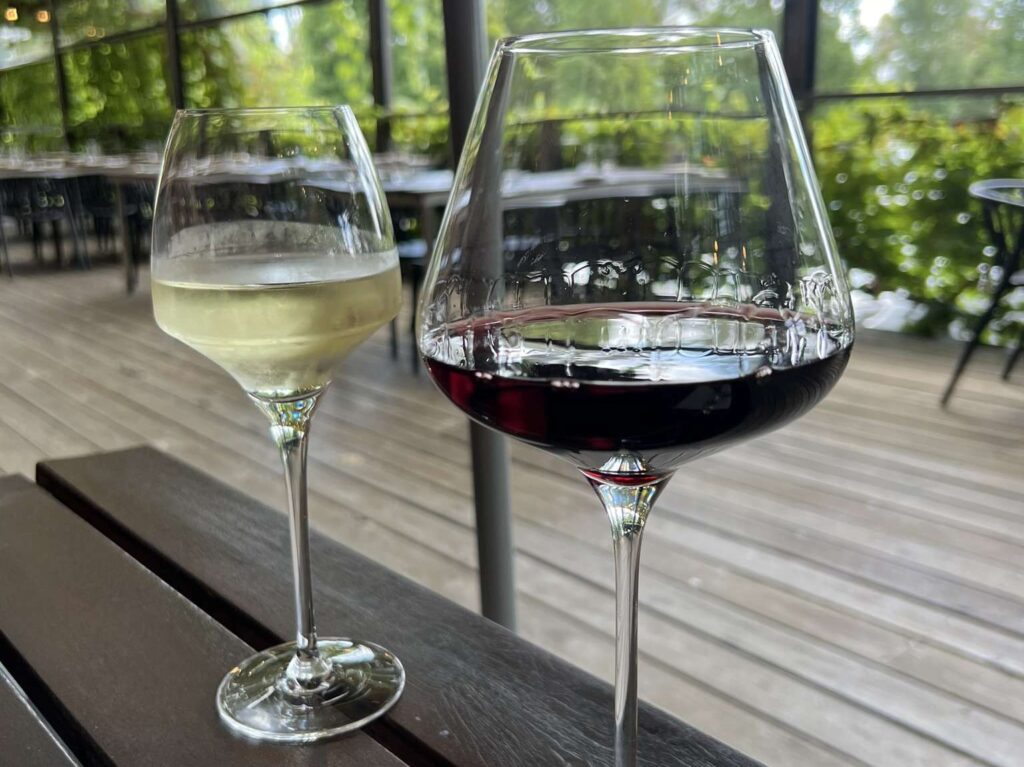 A glass of red and white wine on a table - australia food and drinks