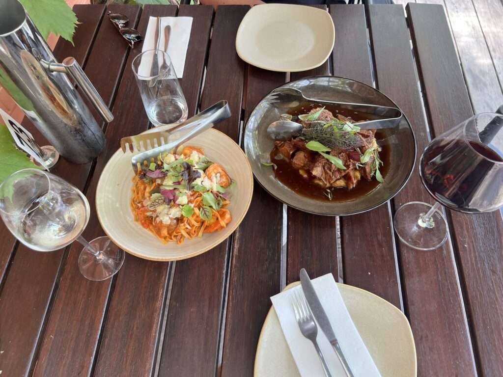 a few plates of food and glasses of wine - australia food and drinks