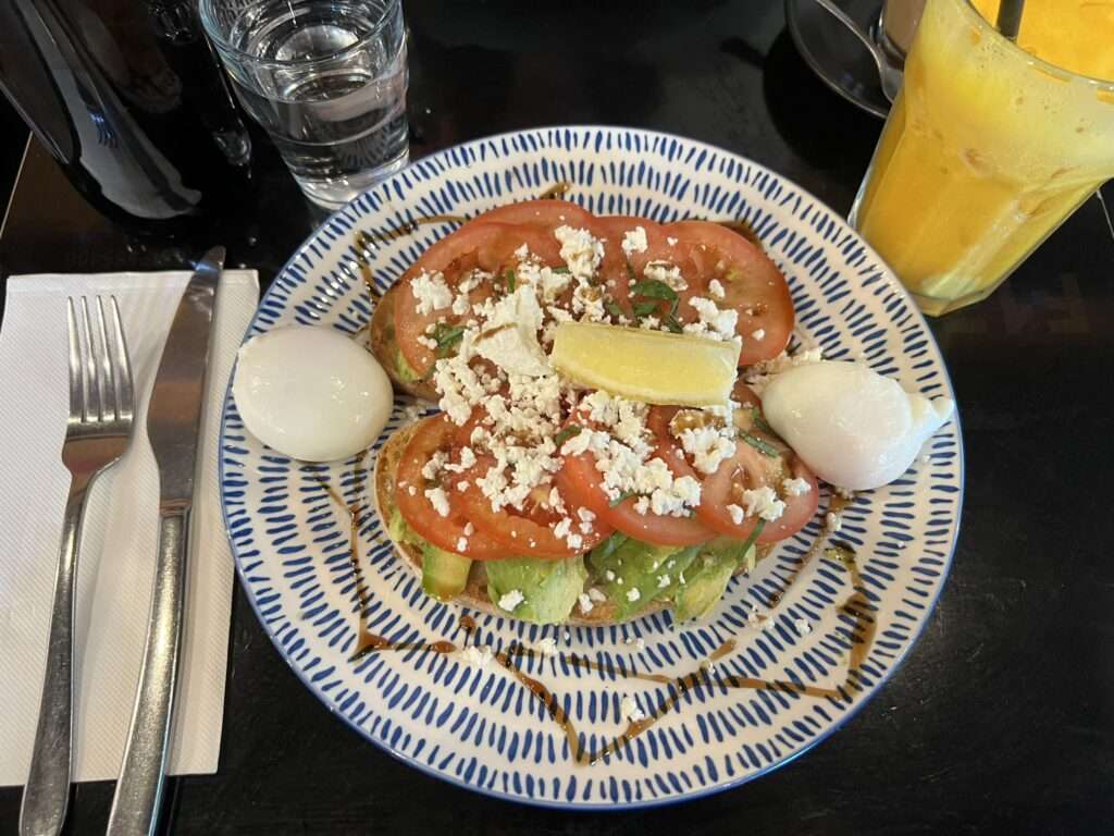 Avocado and tomatoes on toast on a plate - Australia food and drinks