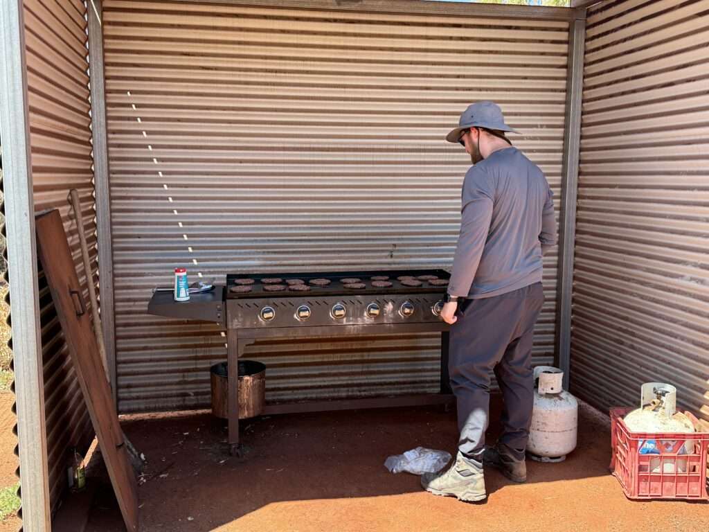 A man standing in front of a barbecue - Australia food and drinks