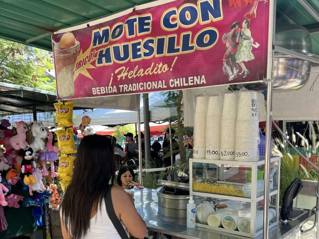 A girl ordering food at a food stand - Chile food