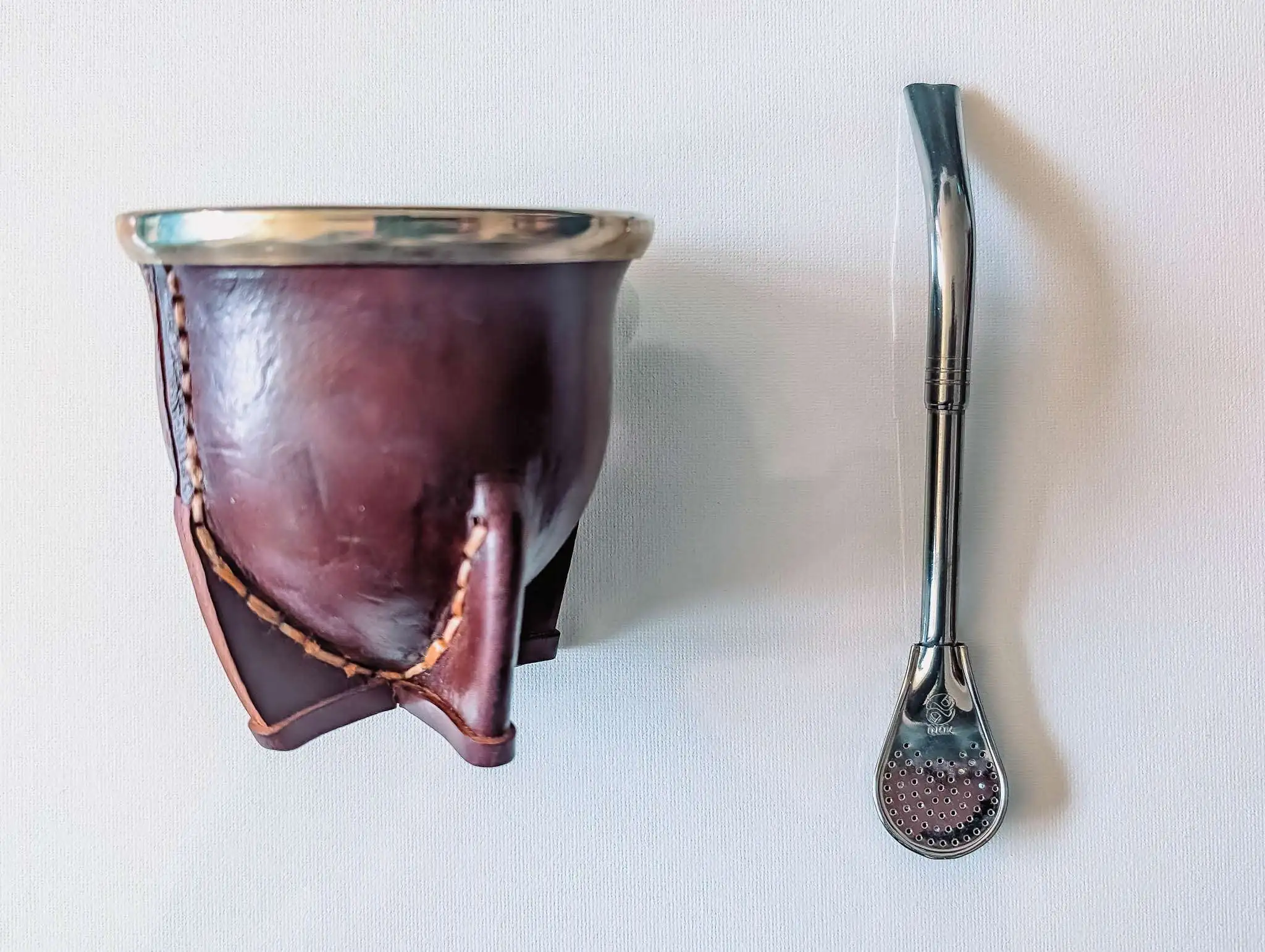 a gourd-like cup and metal straw - Argentina food and drinks