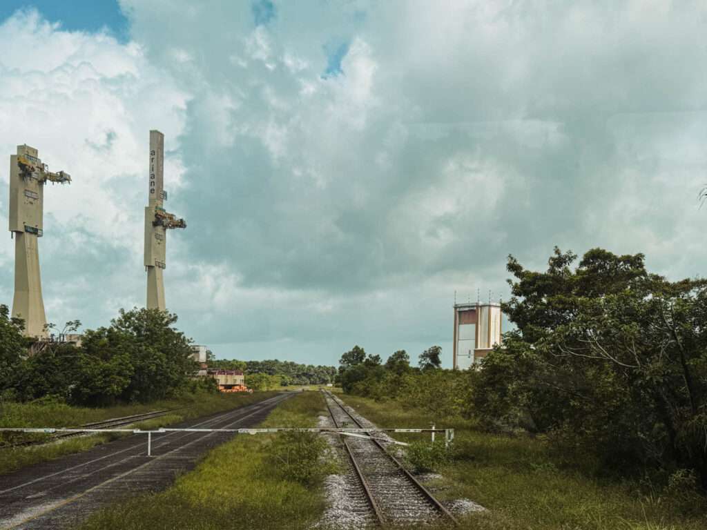 The view down a track with two rocket launch pads in the distance as part of a French Guiana itinerary