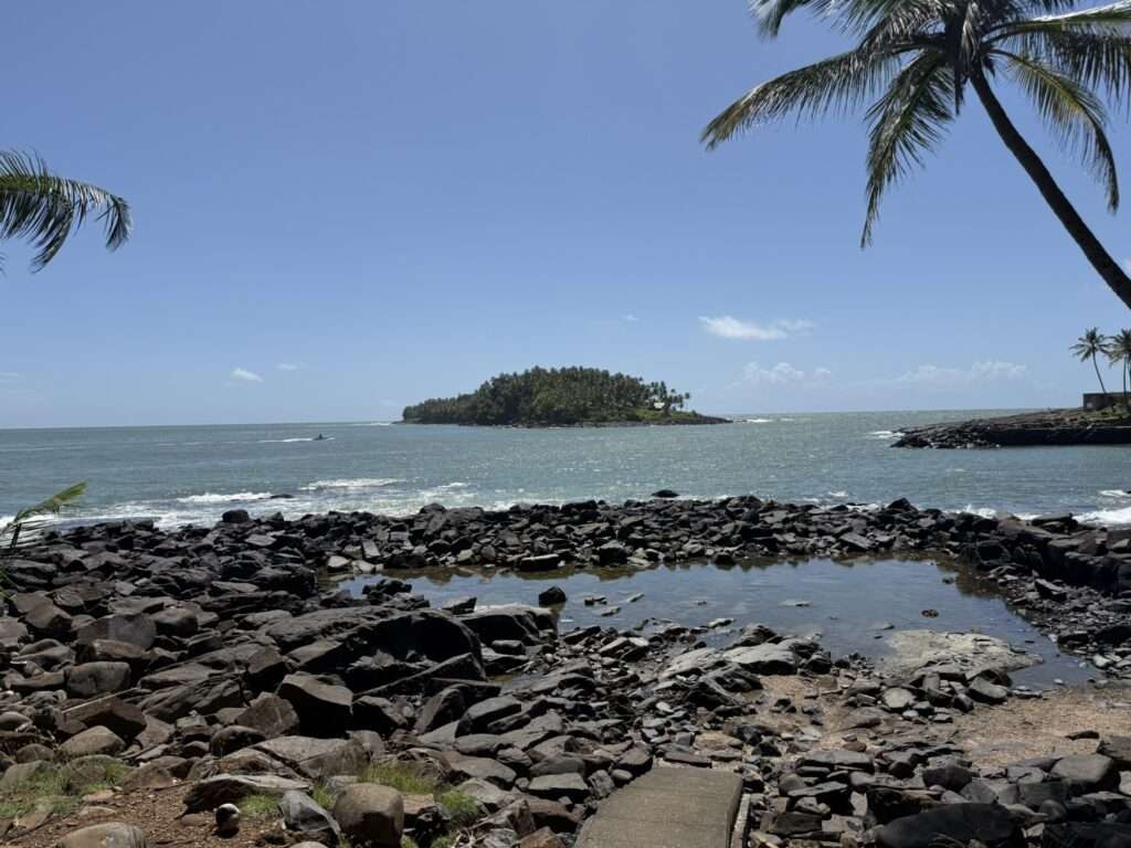 The view off a tropical island onto other islands in a turquoise ocean in French Guiana