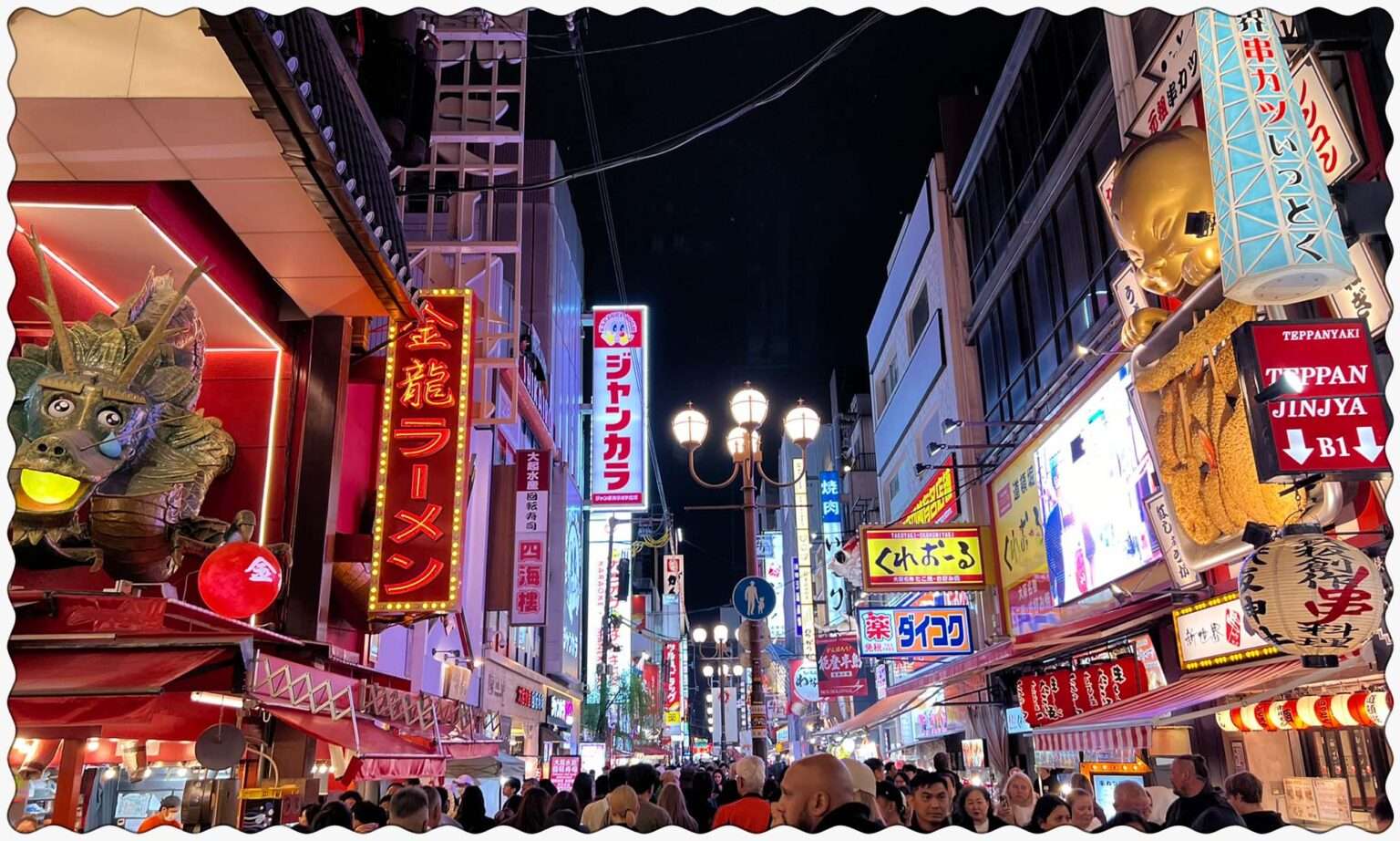 The lit up streets of Osaka, Japan full of neon signs on the high-rises