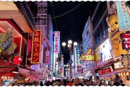 The lit up streets of Osaka, Japan full of neon signs on the high-rises