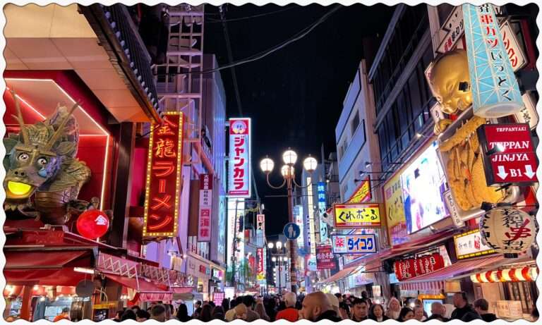 The lit up streets of Osaka, Japan full of neon signs on the high-rises