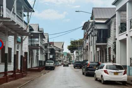 Looking down a street with colonial buildings on each side as part of a Suriname itinerary