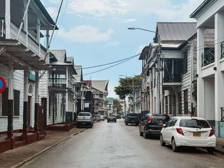 Looking down a street with colonial buildings on each side as part of a Suriname itinerary