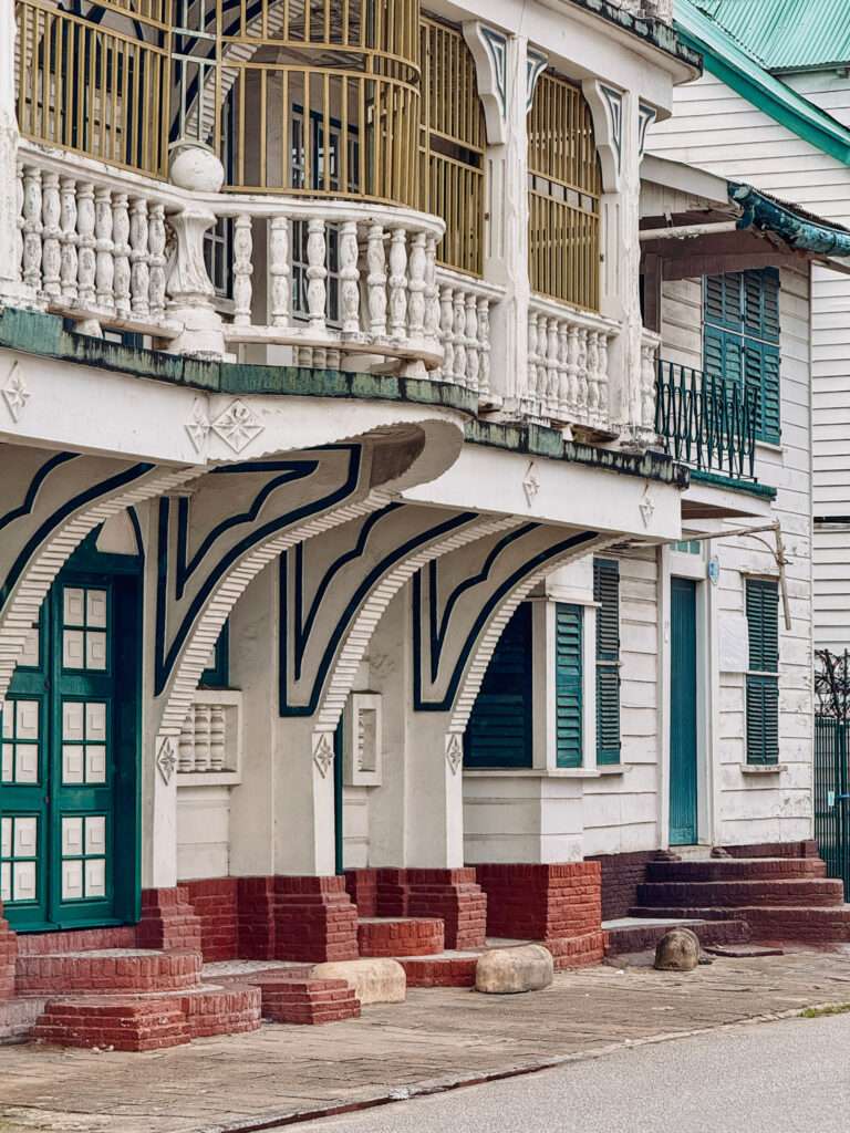 A row of colonial buildings with a lot of detail that can be seen in a Suriname itinerary