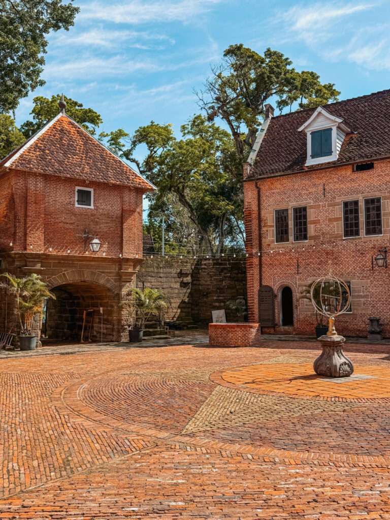 A few brick buildings around a brick square as part of the Suriname itinerary