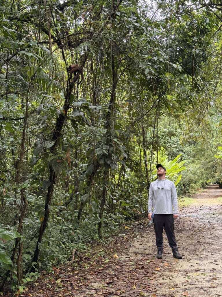 A man standing on the path of a forest of Suriname at one of the former plantations