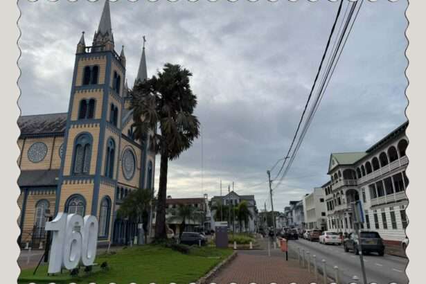 Looking down a street in Suriname with a yellow and blue wooden church on one side