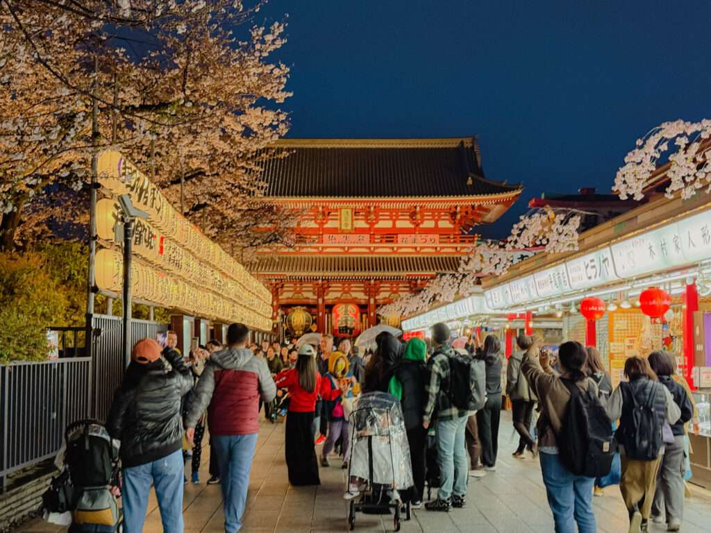 The pathway to the Senso-Ji temple is lined with shops on one side and sake barrels on the other