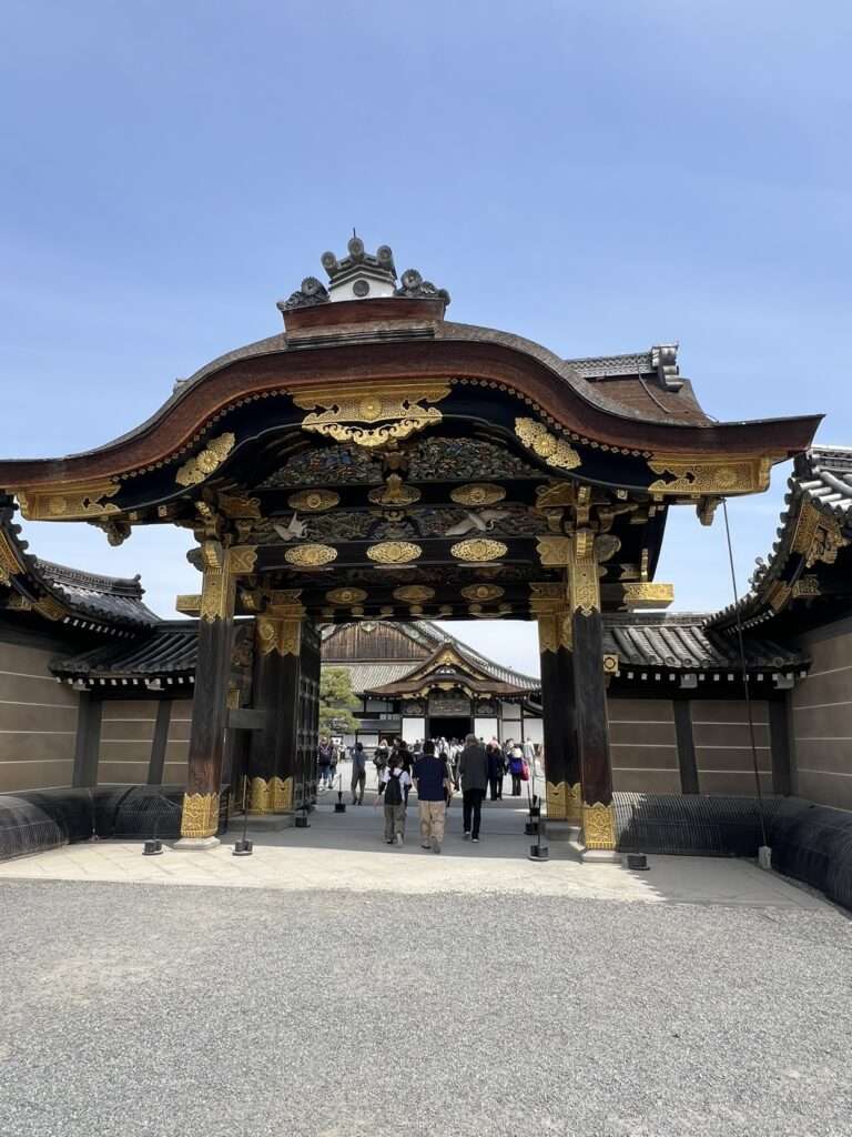 A highly decorated wooden and gold entrance gate to a castle