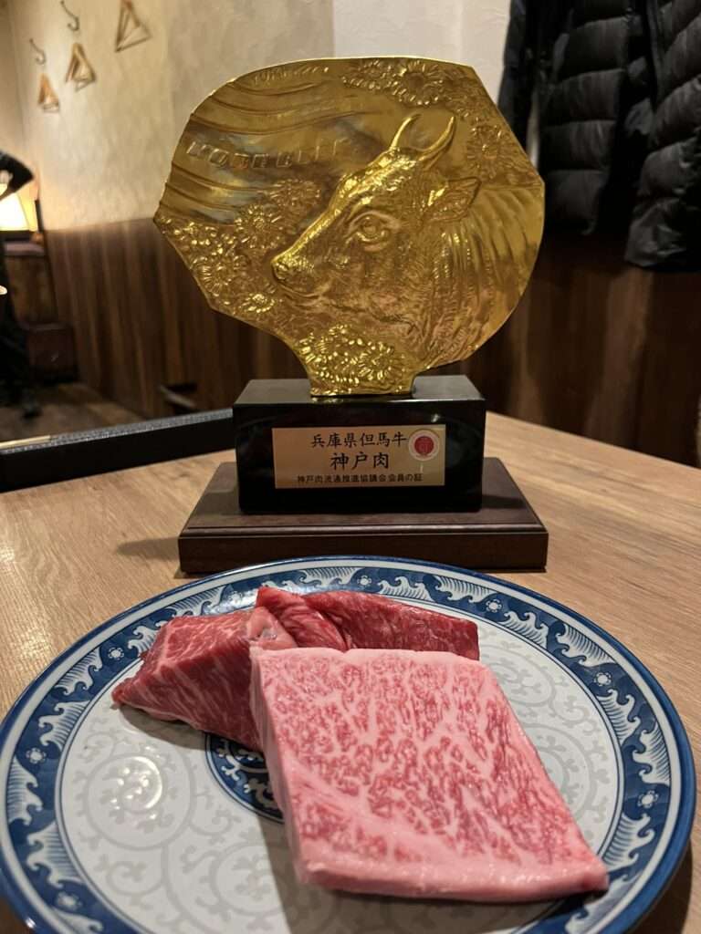 A few different cuts of beef in front of a gold award indicating that it is certified wagyu