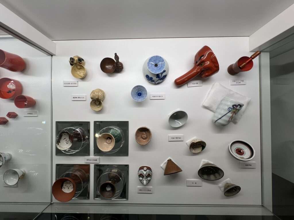 A museum display of historical sake cups to show how they have changed over time
