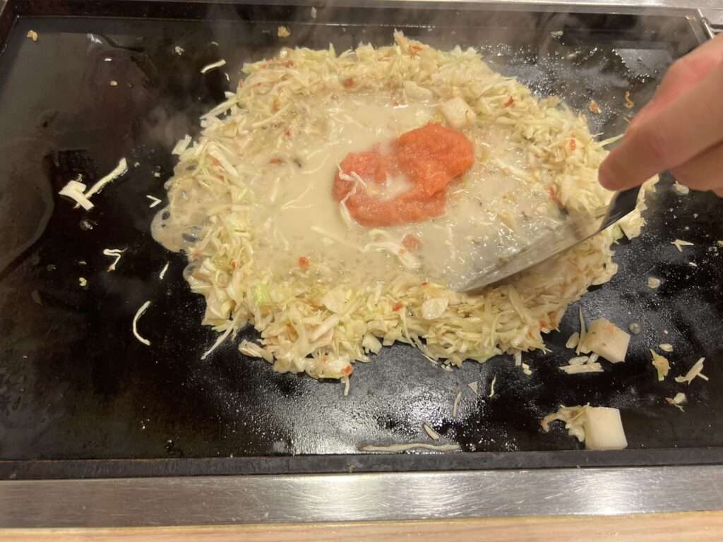 The monjayaki dish from Tokyo, Japan cooking on a sizzling griddle