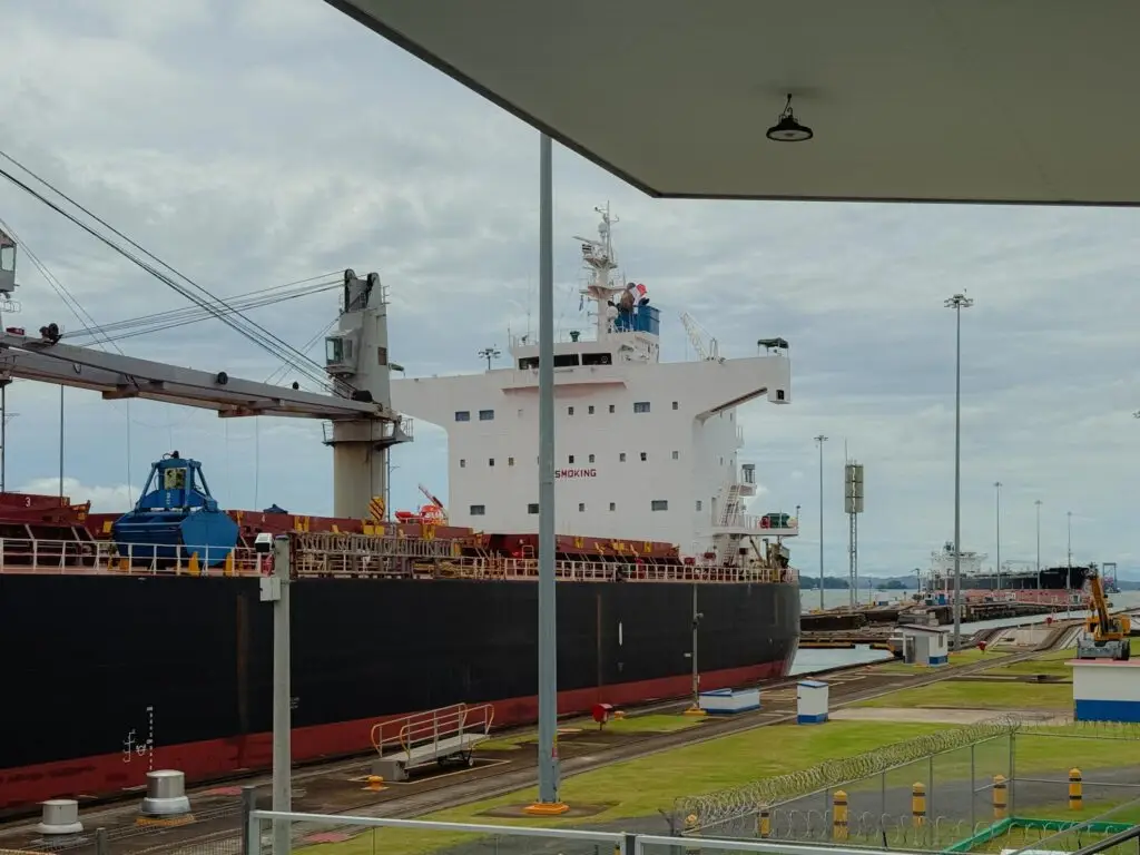 A bulk carrier filling the original Gatun lock chamber viewed from close range at the Agua Clara old locks viewing area, Panama Canal
