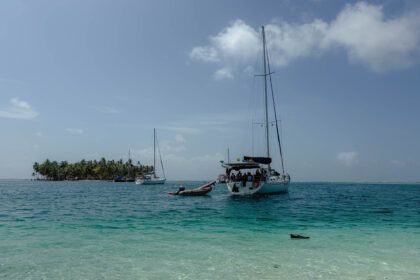 Sailboat anchored in turquoise water off a palm-lined San Blas island, Guna Yala, Panama -- day trips from Panama City