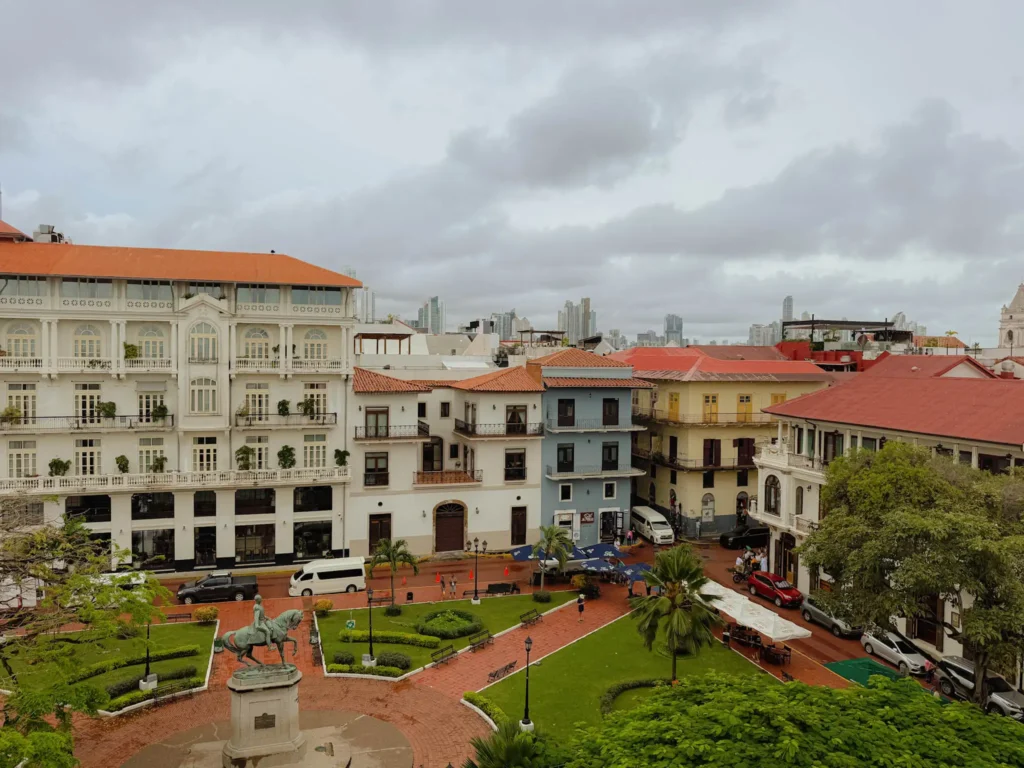 Plaza Herrera in Casco Viejo with colonial buildings and the Panama City skyline rising behind — Casco Viejo architecture walk