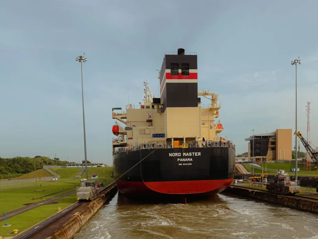 The bulk carrier Nord Master inside a Panama Canal lock chamber with mule locomotives on either side — Panama Canal tour