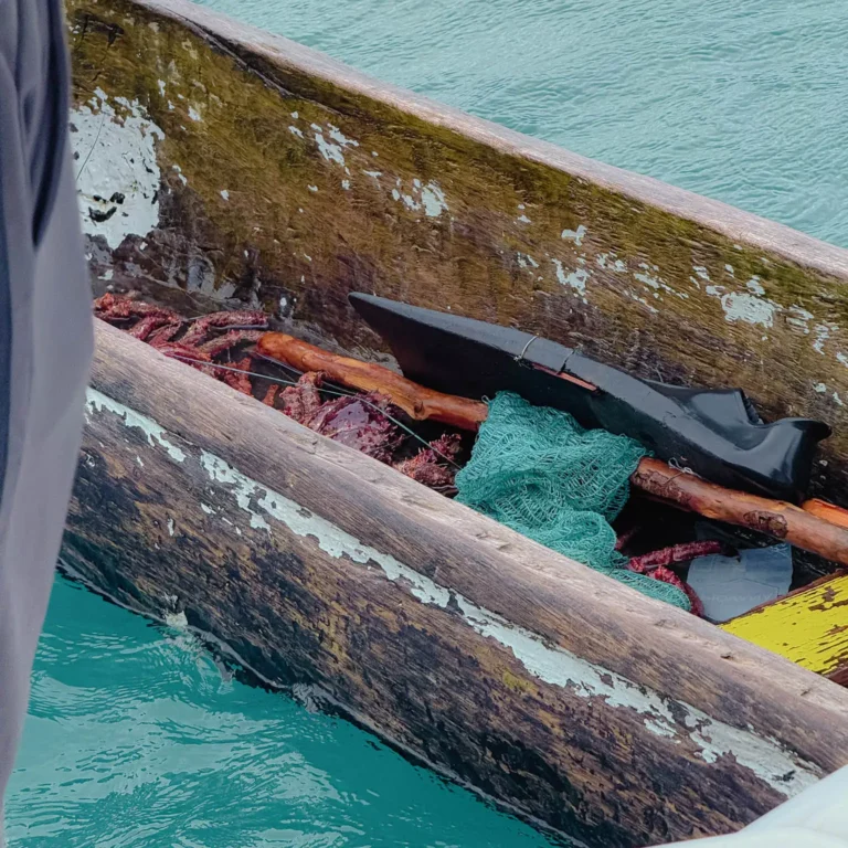 Traditional Guna wooden dugout canoe with fishing nets on the turquoise waters of San Blas - Guna Yala Panama