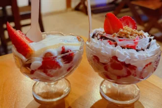 Two glass cups of fresh strawberries and cream topped with whipped cream at El Poder De Las Frutas in Boquete Panama -- Boquete Panama