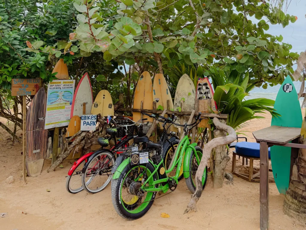 Fat-tire e-bikes parked among surfboards near Playa Bluff on Isla Colon