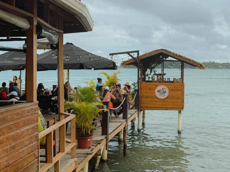 Over-water restaurant deck with diners on Isla Carenero, Bocas del Toro