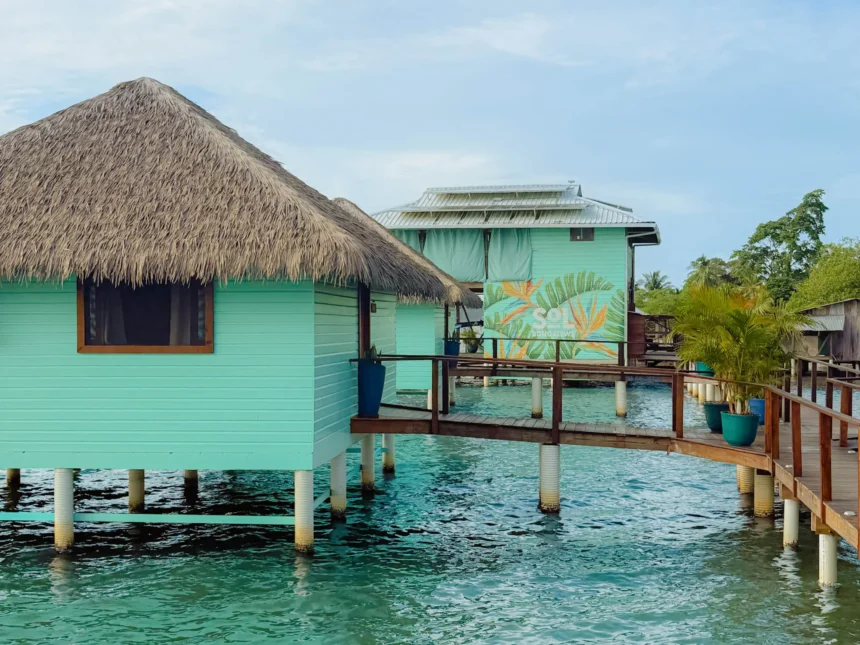 Turquoise over-water bungalows with thatched roofs at Sol Bungalows, Bocas del Toro