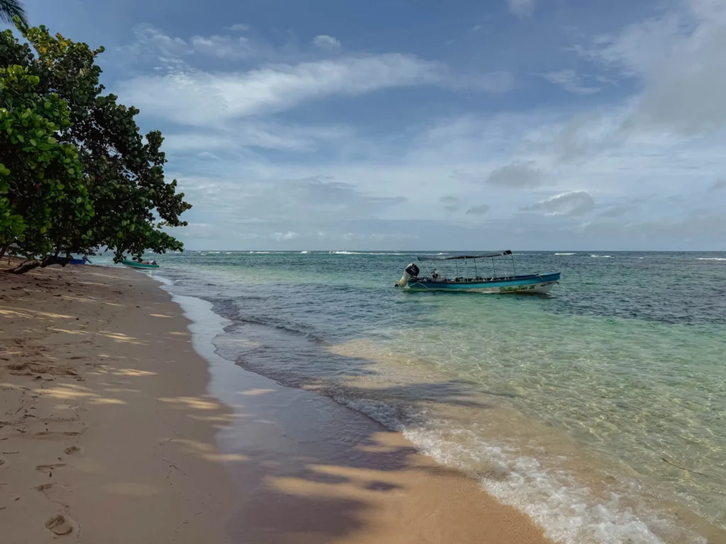 Tour boats anchored offshore at Polo Beach in Bocas del Toro, Panama