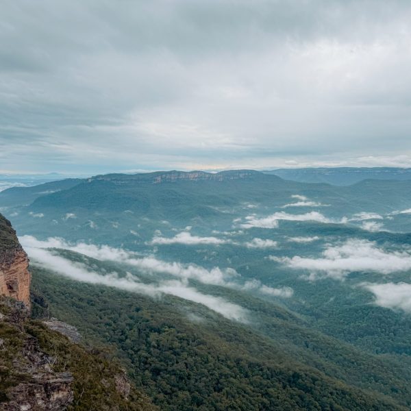Australia – Sydney-004 The view over a large valley with blue-like trees and some cloud cover - Blue Mountains 1 day itinerary