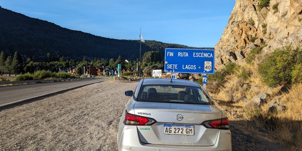 A car on the side the road in front of a sign - what to do in bariloche - Route of the Seven Lakes