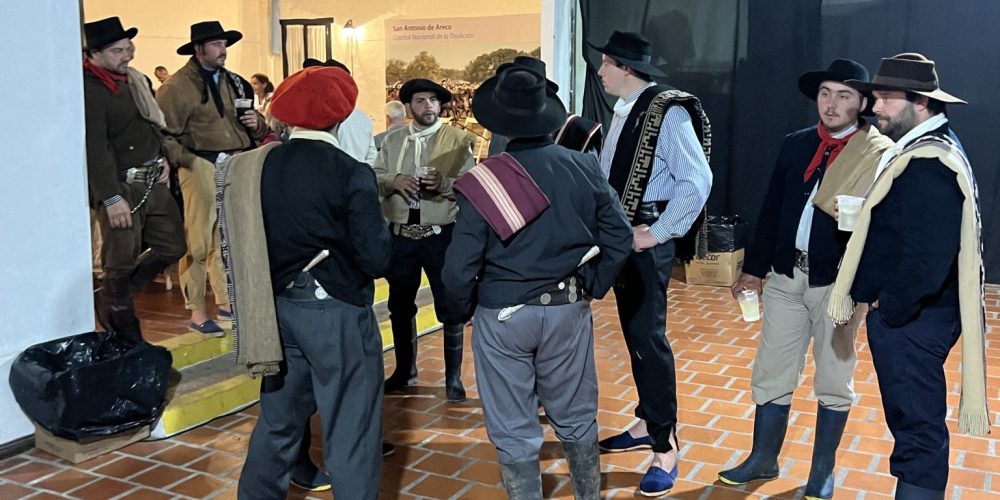 A group of men in period costumes standing around, adding a touch of history and charm to the scene.