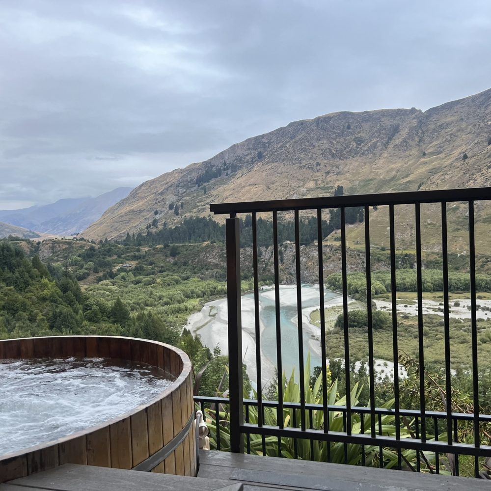 New Zealand-Queenstown-9 A hot tub overlooking a mountain and valley when visiting Queenstown
