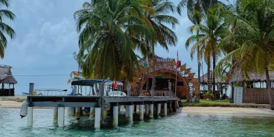 Wooden dock and open-air bar structure on Nugnudub island viewed from the water in San Blas - San Blas Islands Guna Yala