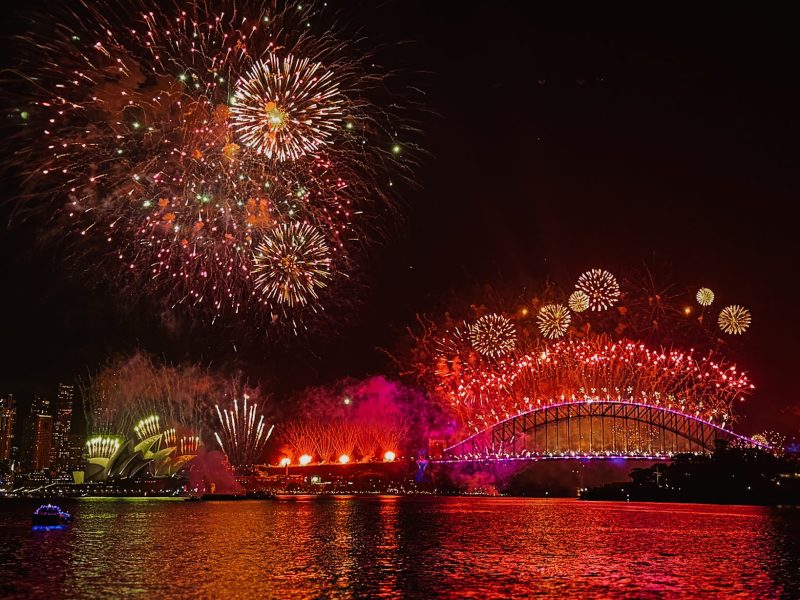 A red firework show over the city skyline of Sydney - New Year's Eve in Sydney