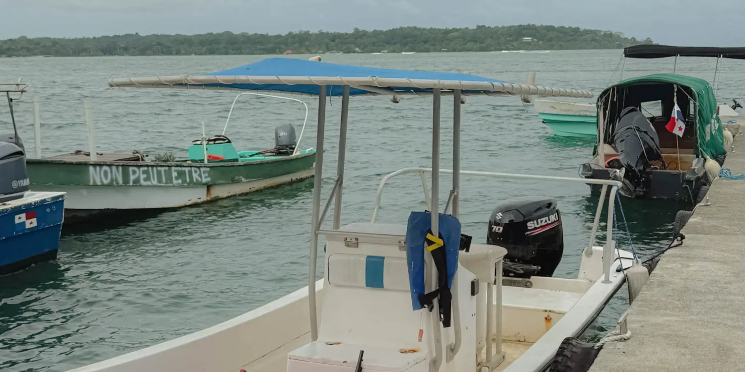 bocas-del-toro-boats-at-dock Small boats moored along a dock under a cloudy sky in Bocas del Toro