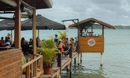 bocas-del-toro-isla-carenero-waterfront-dining Over-water restaurant deck with diners on Isla Carenero, Bocas del Toro