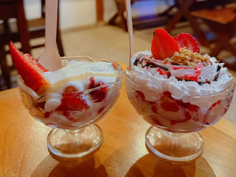 Two glass cups of fresh strawberries and cream topped with whipped cream at El Poder De Las Frutas in Boquete Panama -- Boquete Panama