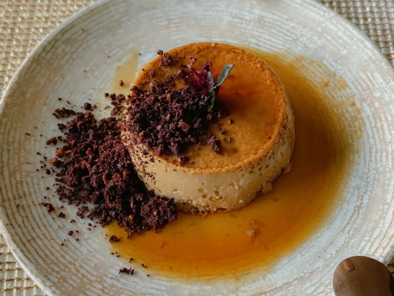 Coffee flan with caramel sauce and chocolate crumble on a ceramic plate at Finca Lerida restaurant in Boquete Panama -- Boquete Panama