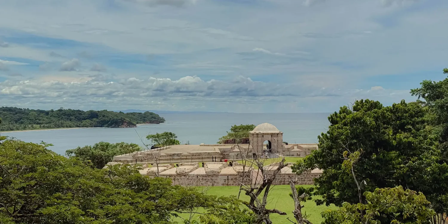 fort-san-lorenzo-elevated-view-caribbean-headland Fort San Lorenzo seen through tropical trees from an elevated vantage point with the Caribbean coast behind -- Portobelo Panama