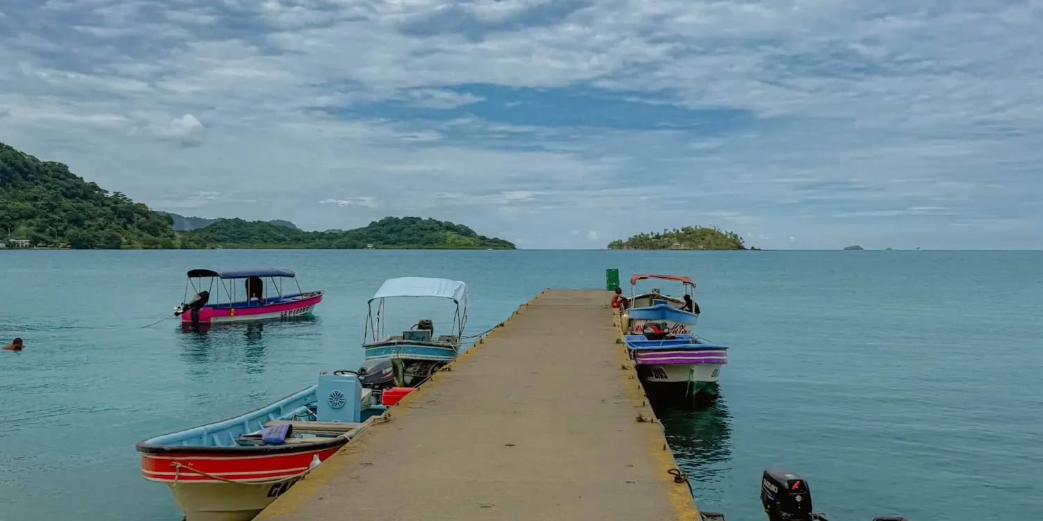 la-guaira-dock-lancha-isla-grande Colorful lanchas moored at the La Guaira dock with Isla Grande visible across the water -- Portobelo Panama