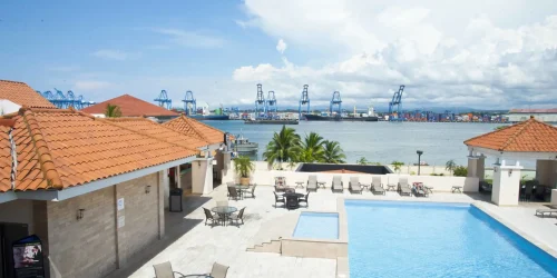 Rooftop pool terrace at the Radisson Colon 2000 with container port cranes and Colon Bay behind -- Portobelo Panama