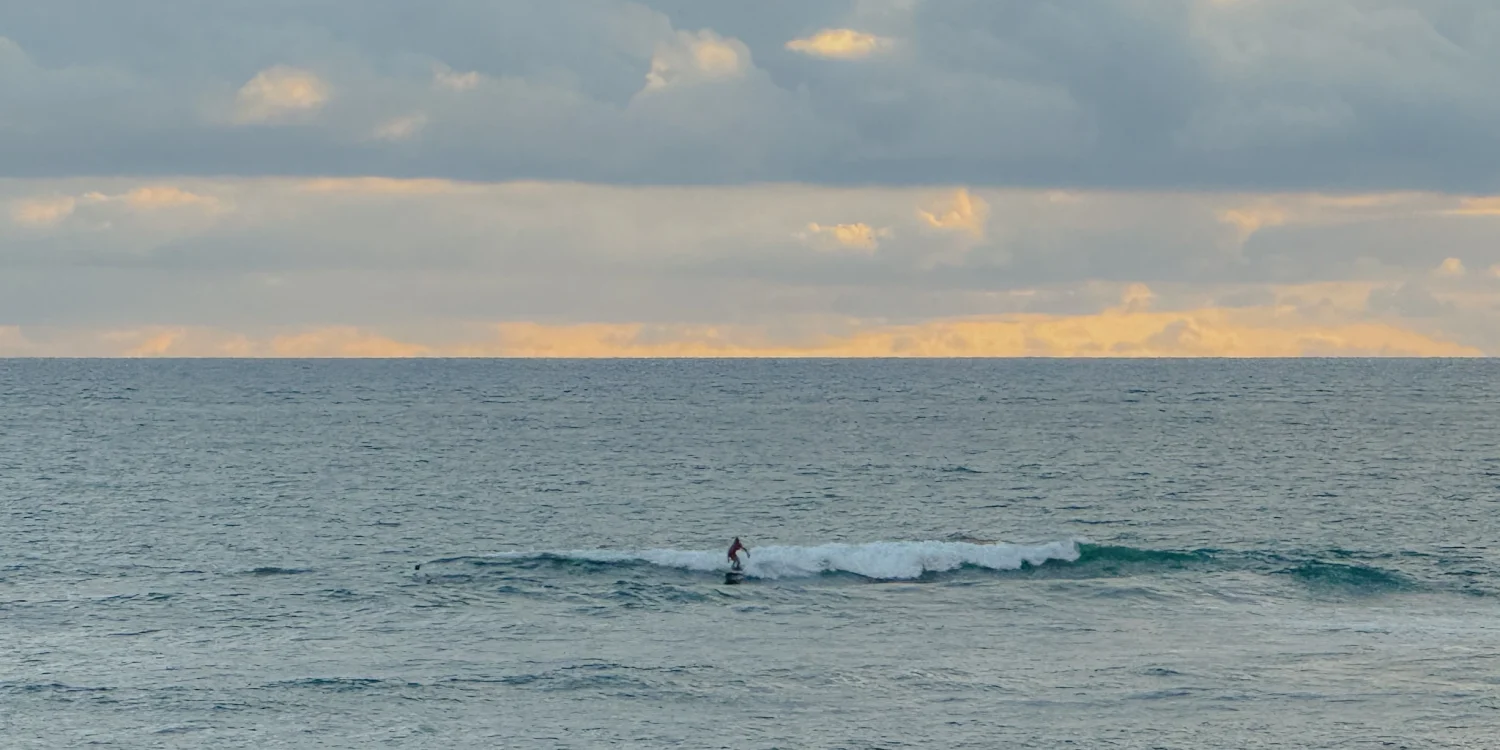 santa-catalina-panama-surfer-sunset Surfer riding a wave at sunset off the coast of Santa Catalina, Panama's Pacific surf town
