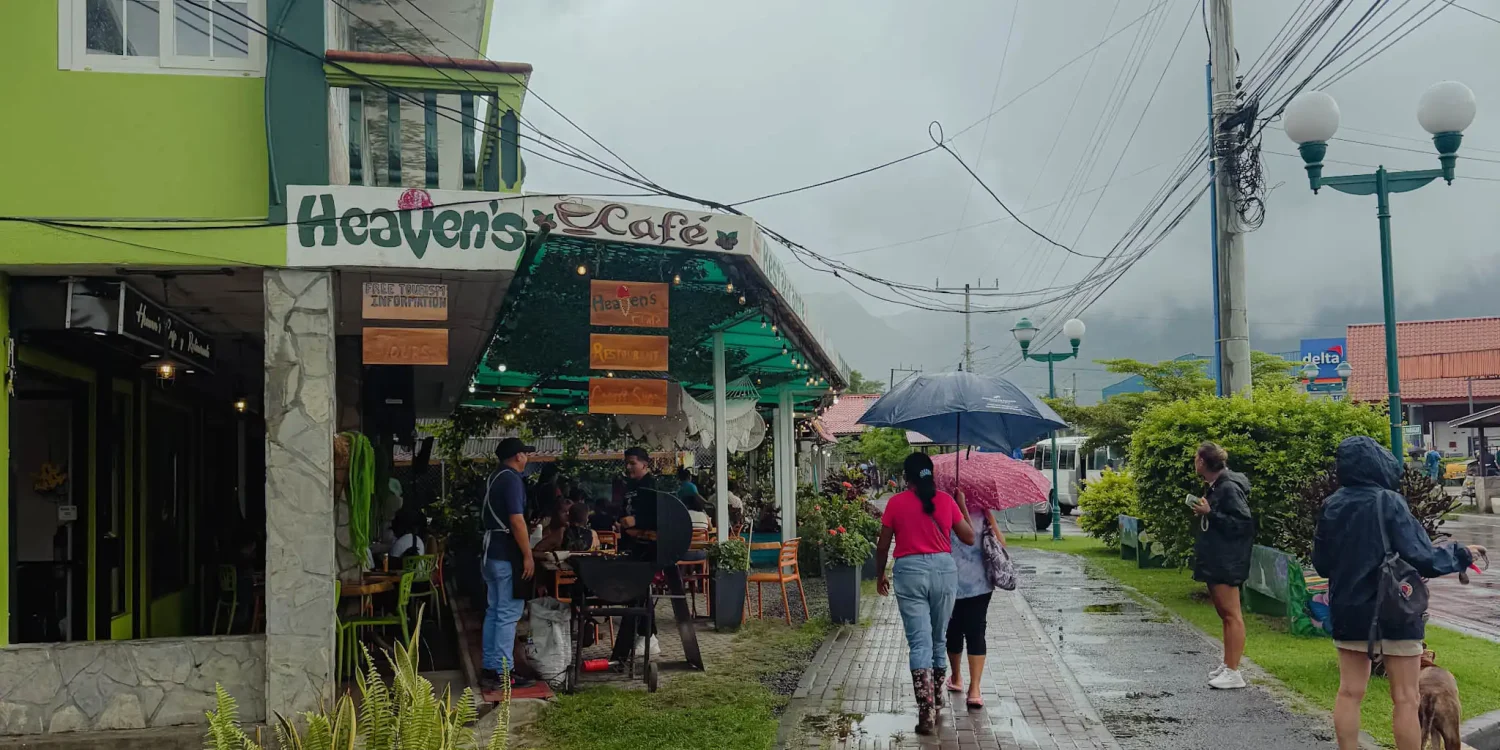 Heaven's Cafe on the main street of Valle de Anton on a rainy day with locals and tourists sheltering under umbrellas -- Valle de Anton Panama